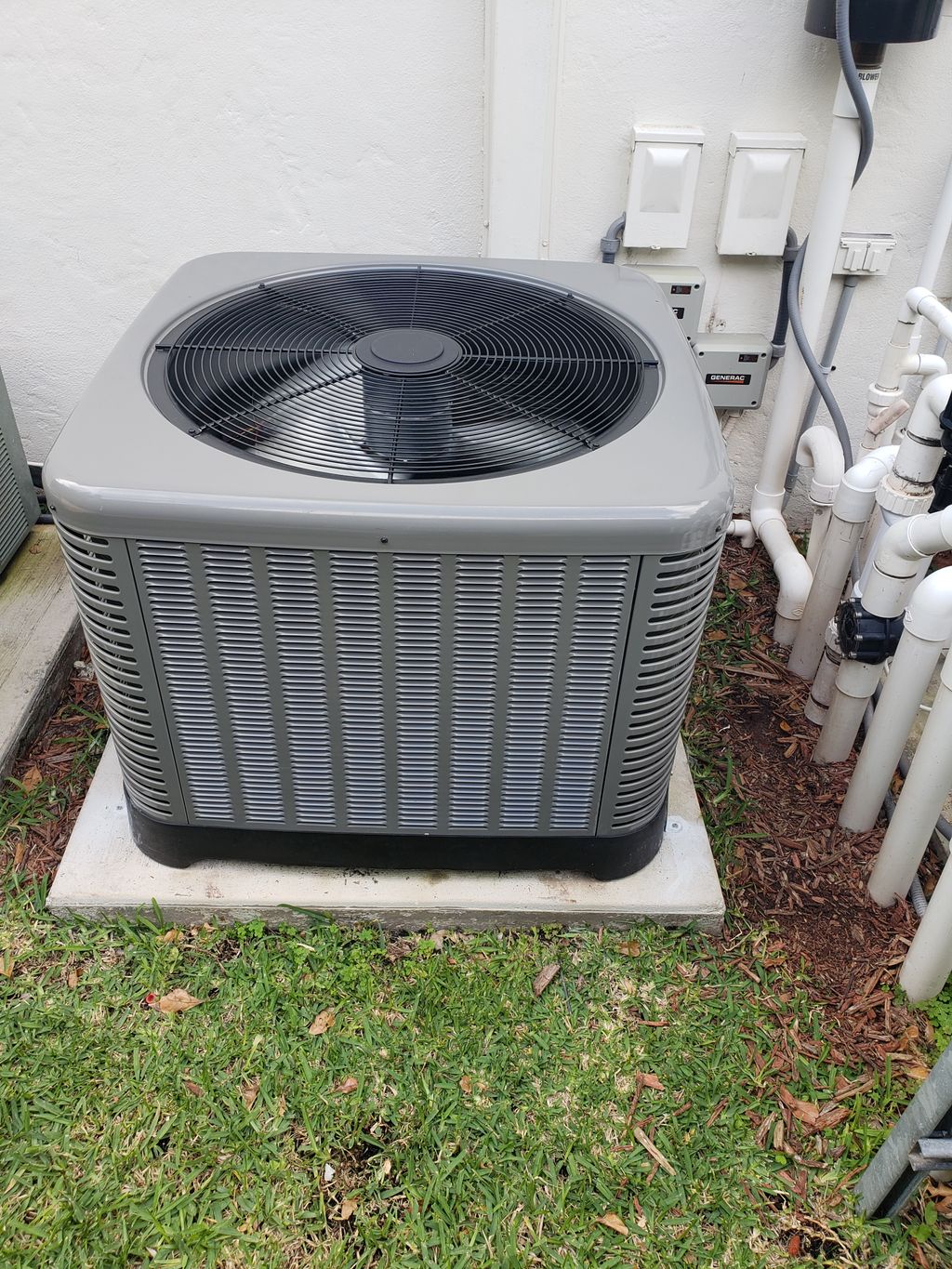 Installation of a rheem condenser unit.