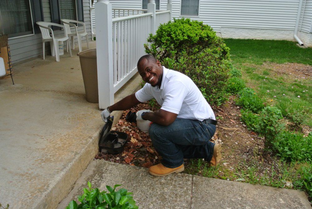 Clifford refilling a rodent bait station