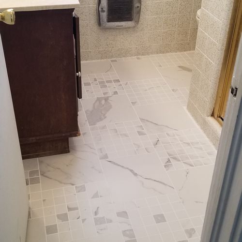 New tile floor installed in a small bathroom. 
