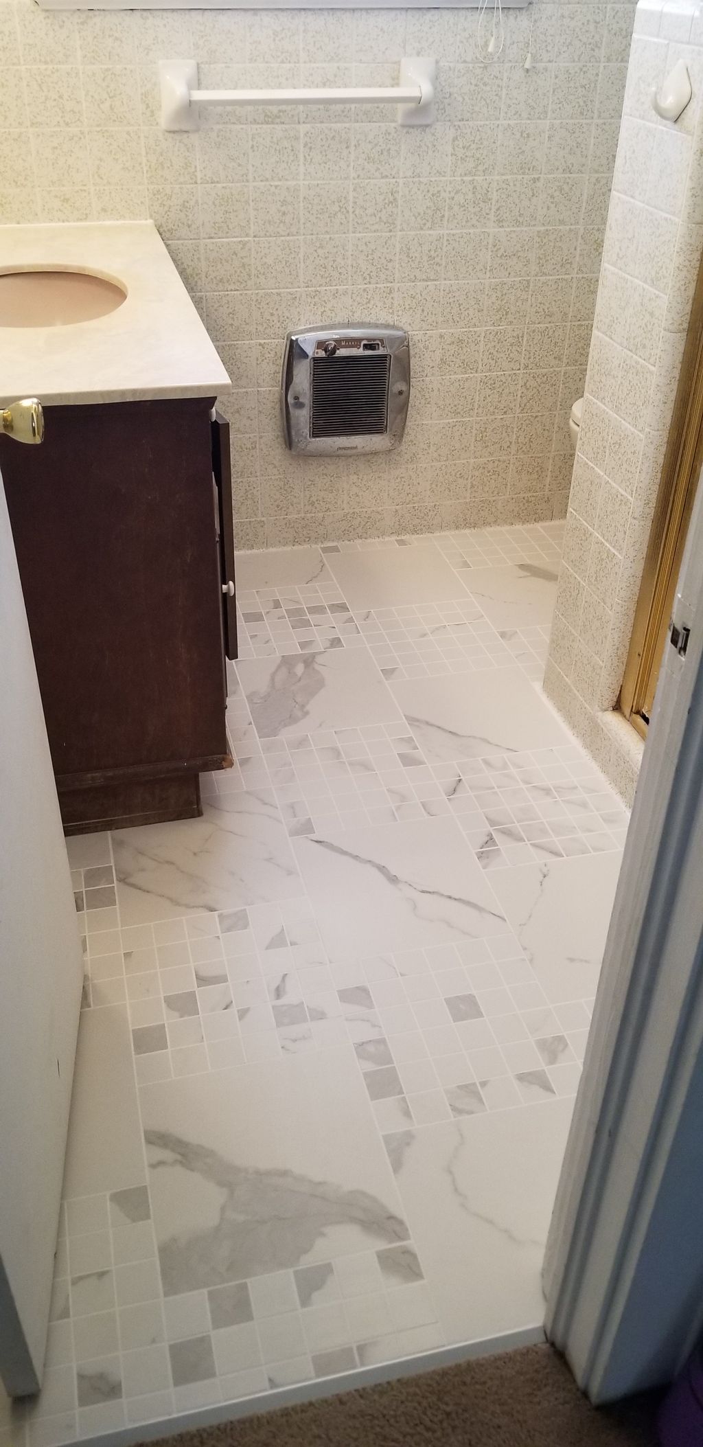 New tile floor installed in a small bathroom. 