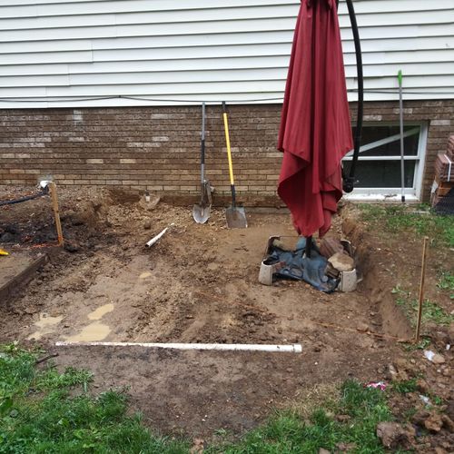 Beginning of a patio, dig to 7 inches.   The hose 