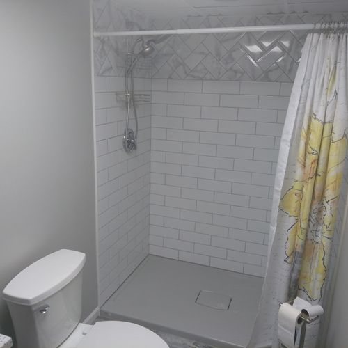 Full bathroom added to a total basement remodel. H