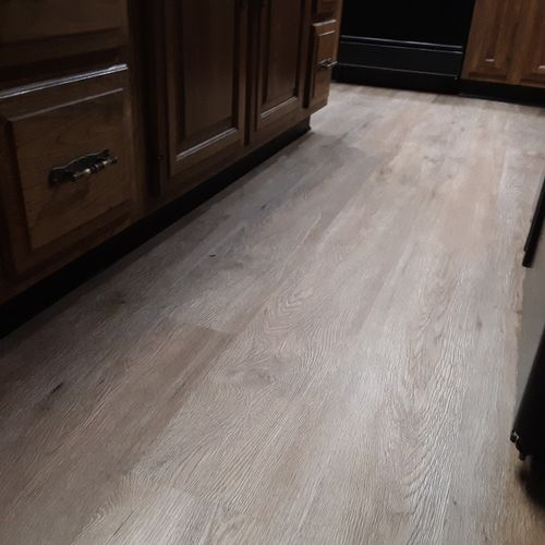 Waterproof flooring with grey and brown variations