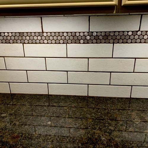 Elongated subway tile with chocolate grout and a f