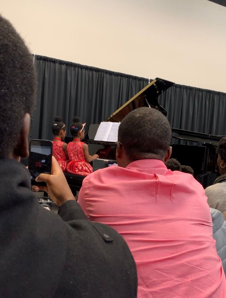 Twins performing a duet at a recital