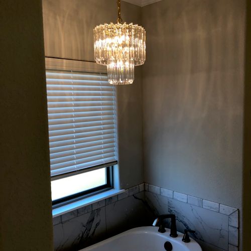 Brandon installed a chandelier in our bathroom tha