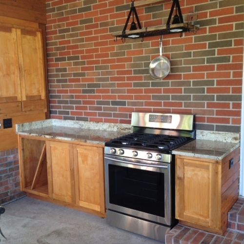 Outdoor kitchenette with granite top.