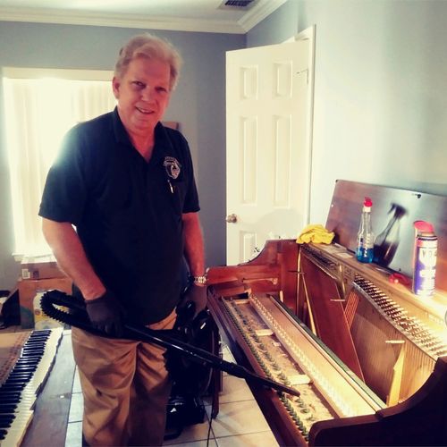 Len Hess cleaning a piano