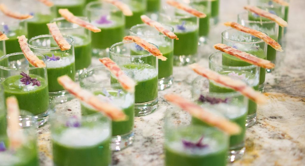Savory chilled pea and leek soup topped with a but