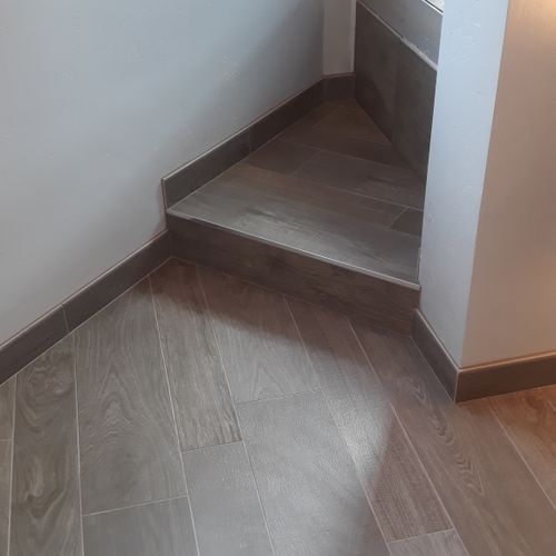 Hardwood floor lookalike porcelain tile with step