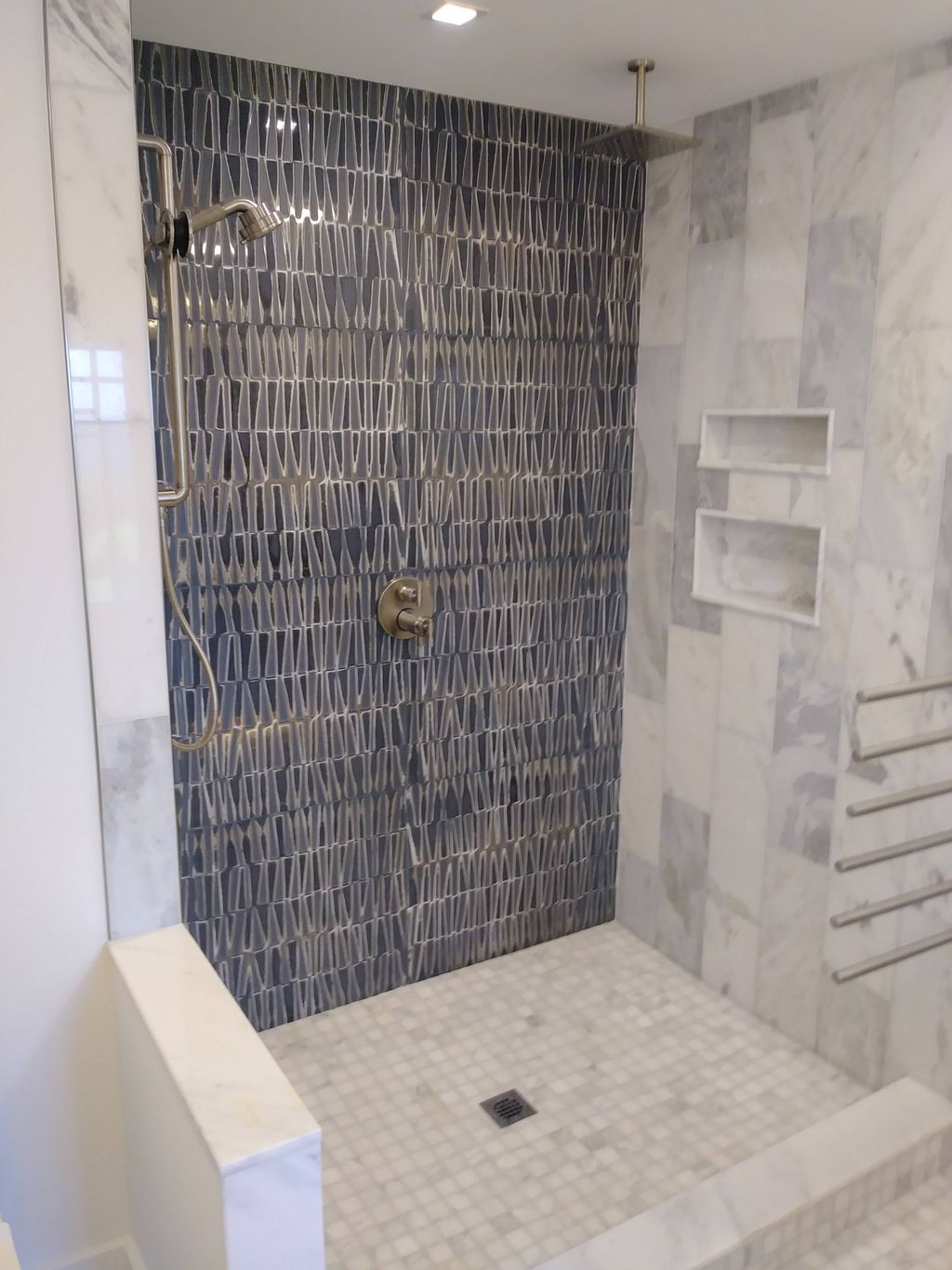 custom shower with artisan tile and marble.