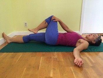 A hip stretch and spinal twist for the low back.