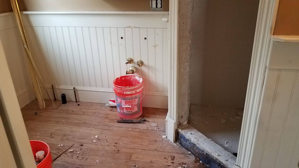 before / during picture of a master bathroom remod