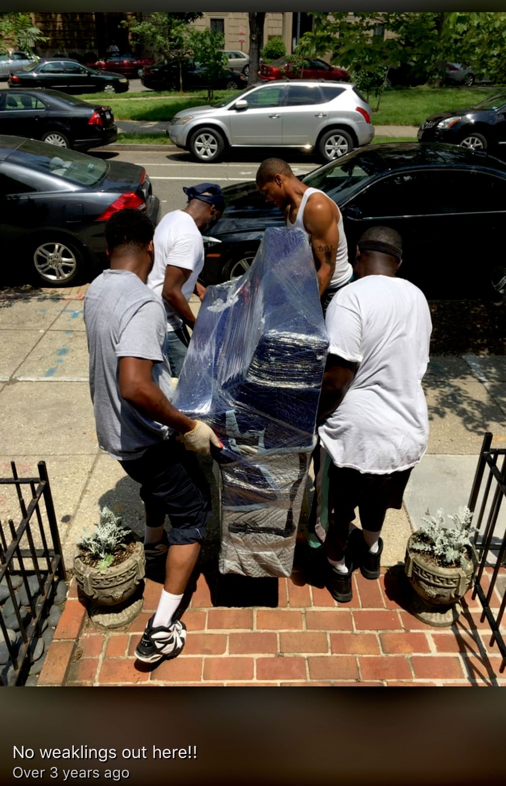 Guys carefully moving a piano