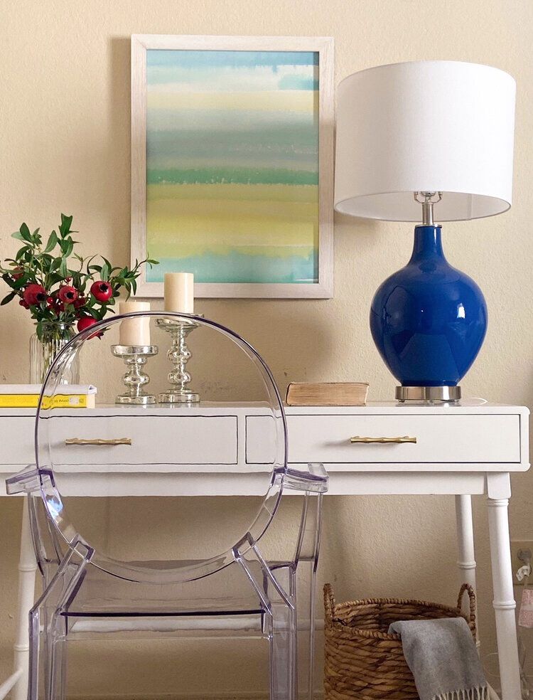 A white desk with faux bamboo details, gourd lamp,