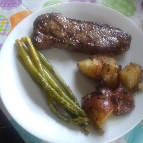 grilled sirloin steak with roasted potatoes and fr