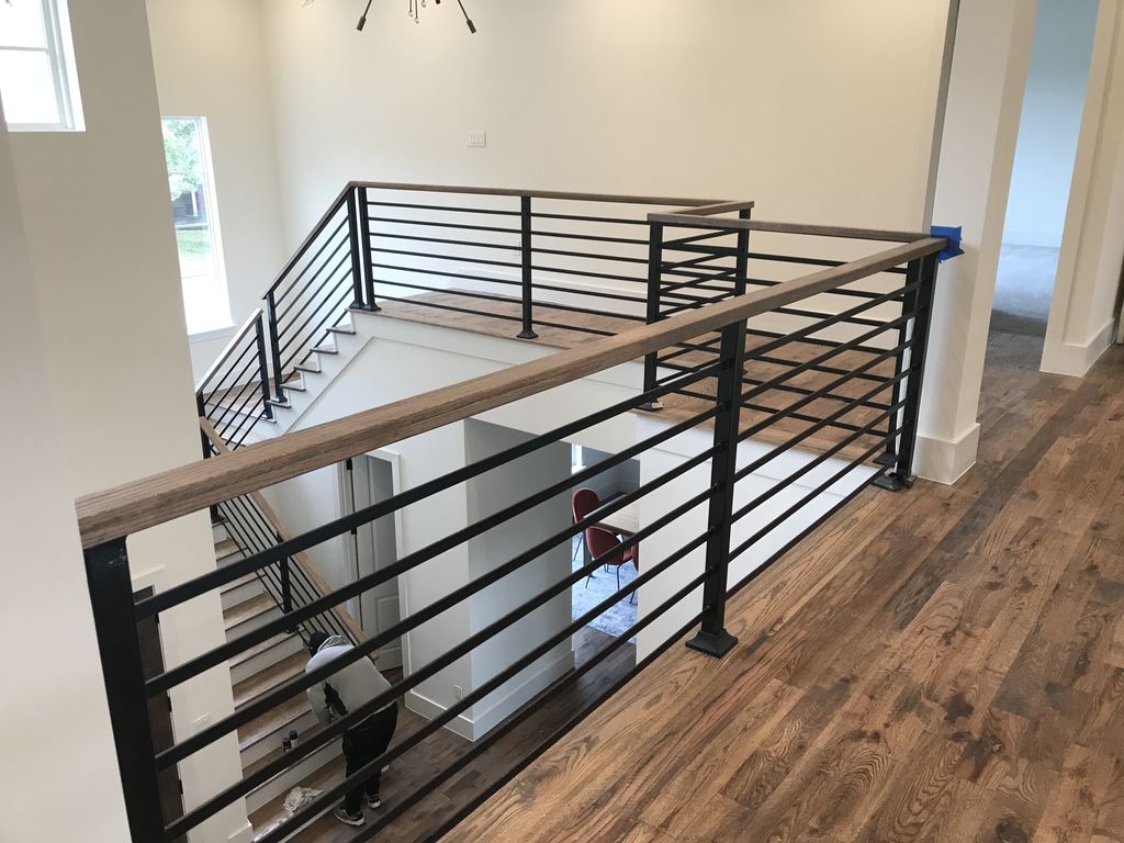 Custom staircase and welded railings @ wood cap st