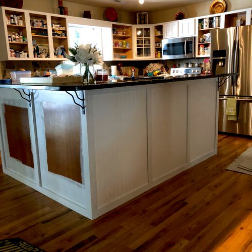 Painted wooden cabinets white and installed wainsc