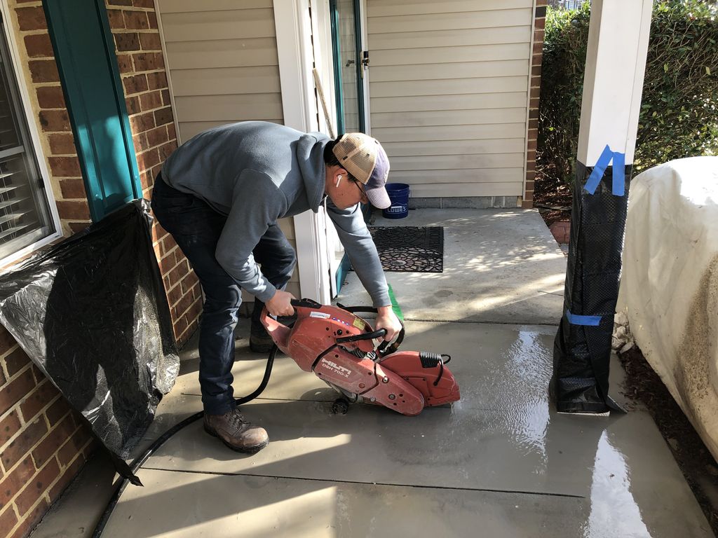 Saw cutting concrete to make a sewer repair
