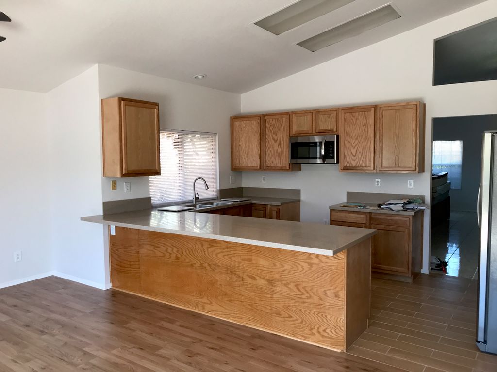 Complete kitchen renovation with new millwork, flo