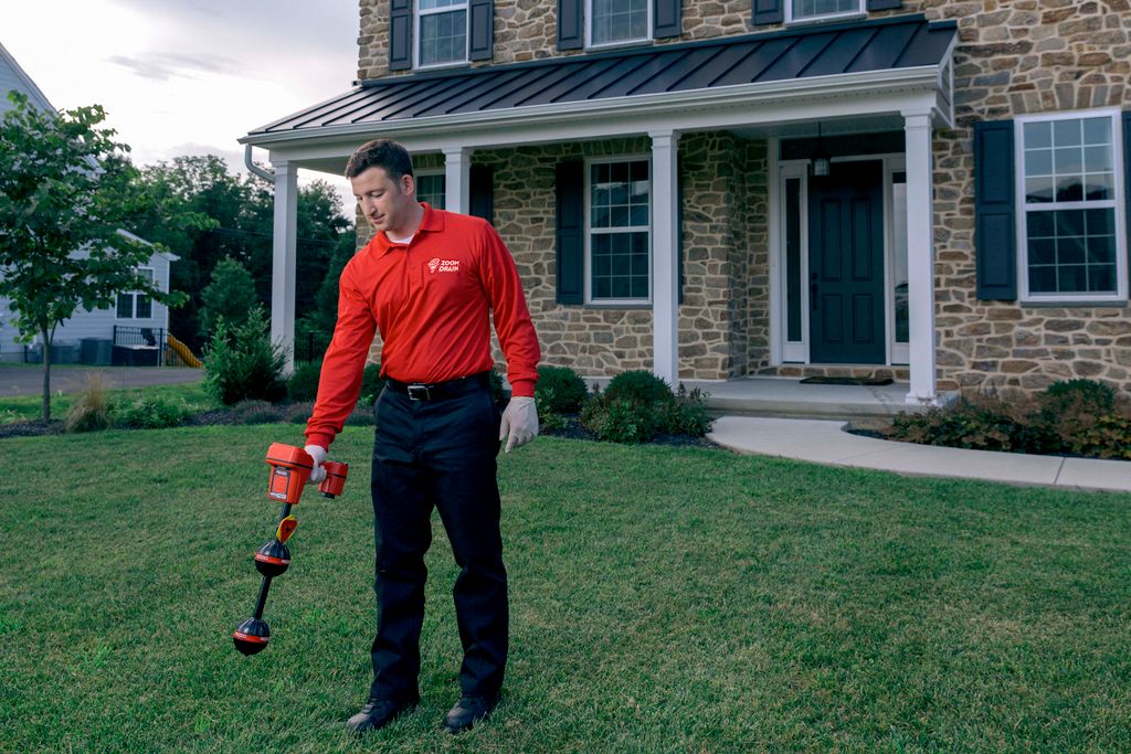 Technician locating sewer lines of customers home.