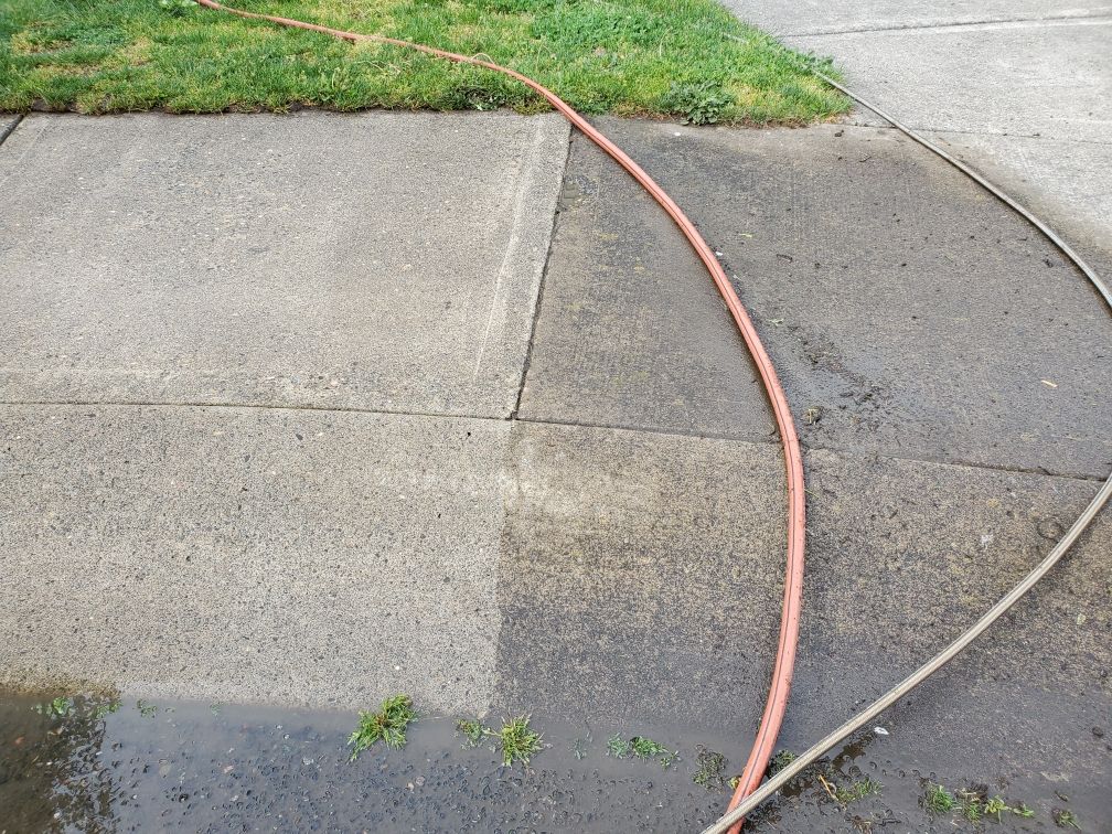 Left side of sidewalk is washed