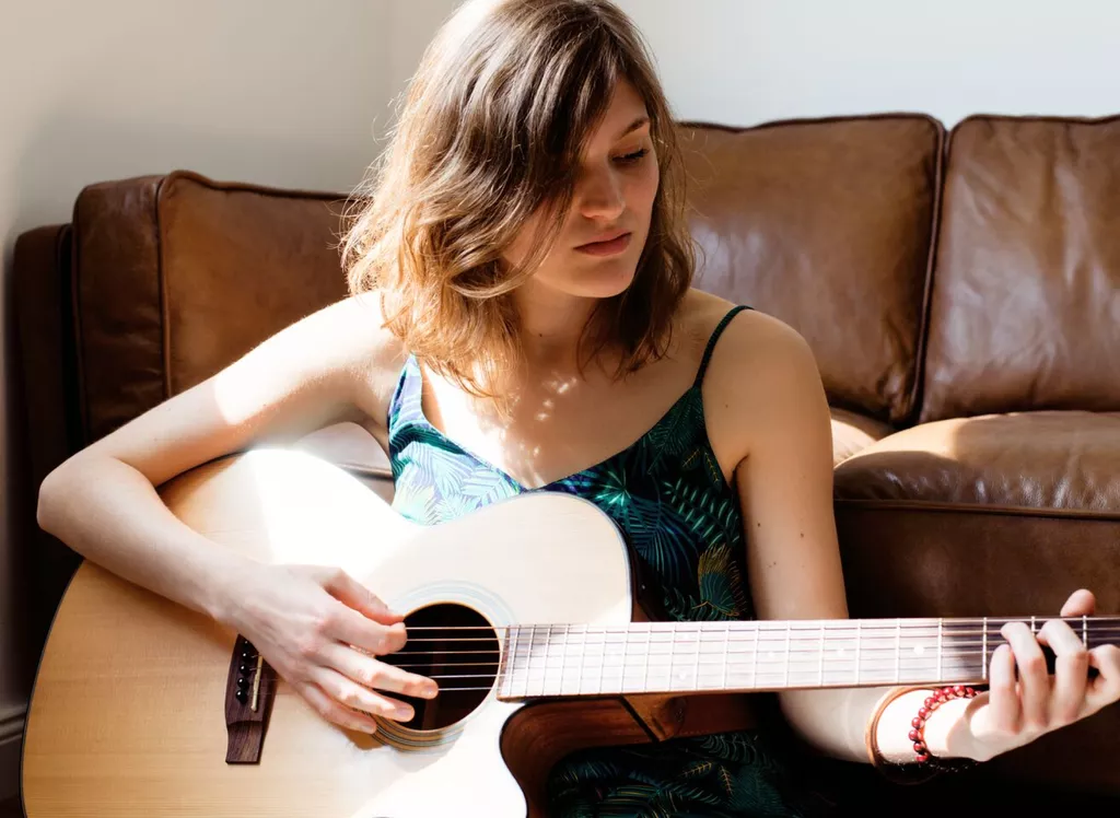 woman playing guitar