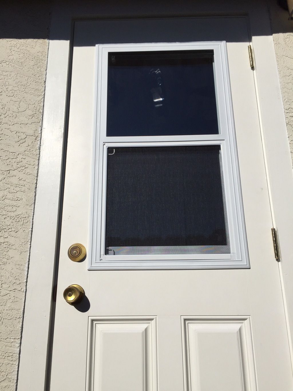 The new prehung door and new trim that replaced ol