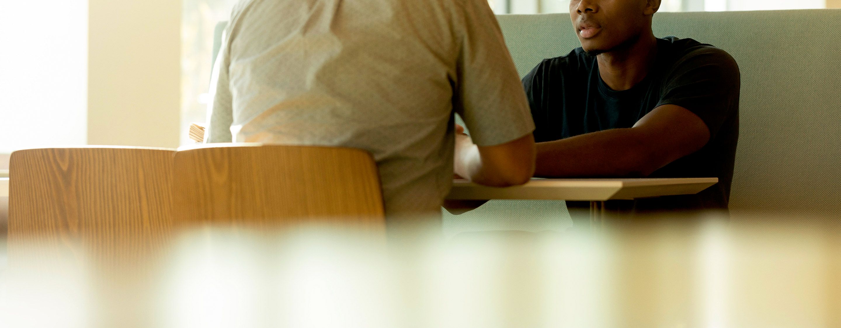 two males sitting at table for job interview