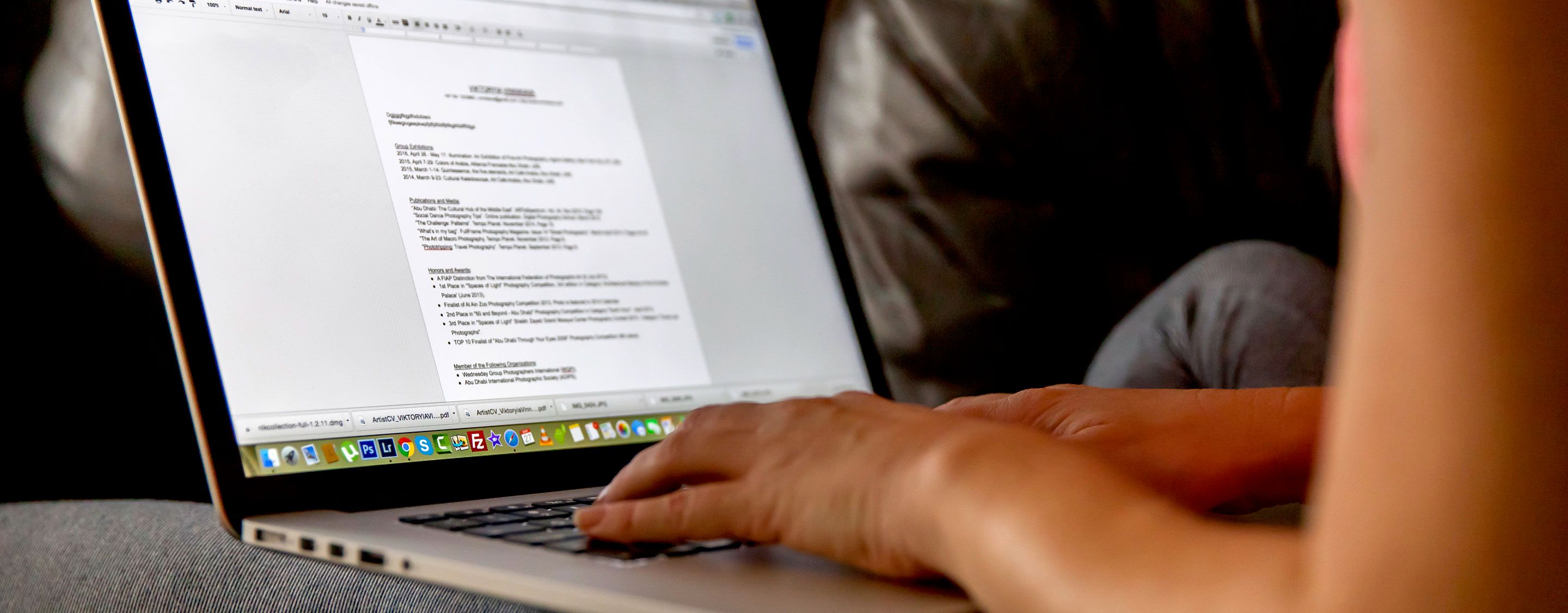 writing resume on laptop