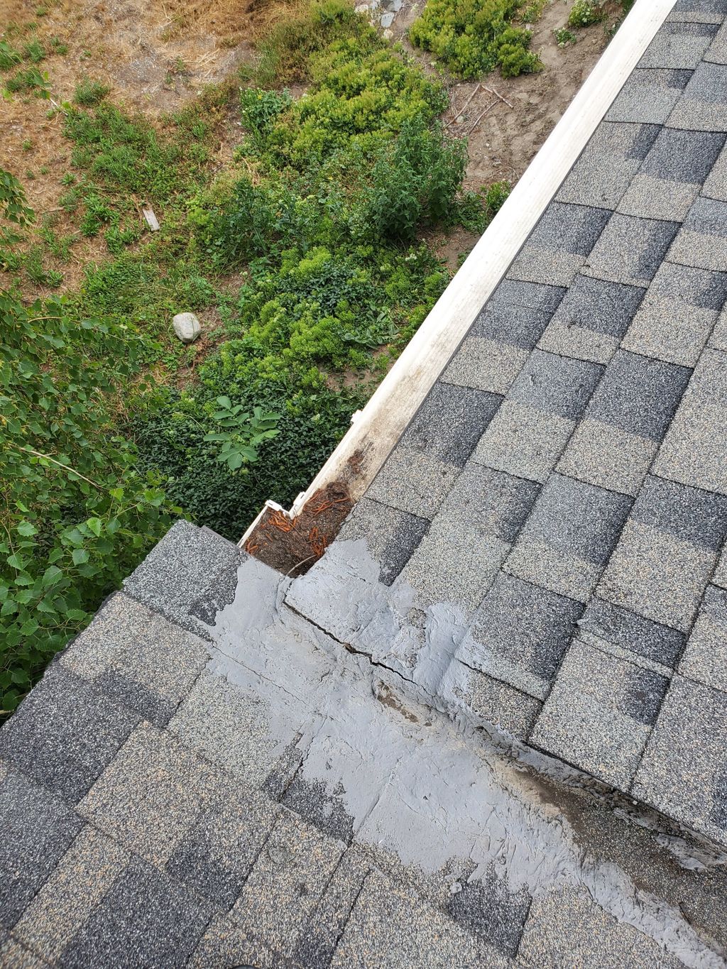 Gutter clogged and improper sealing in roof valley