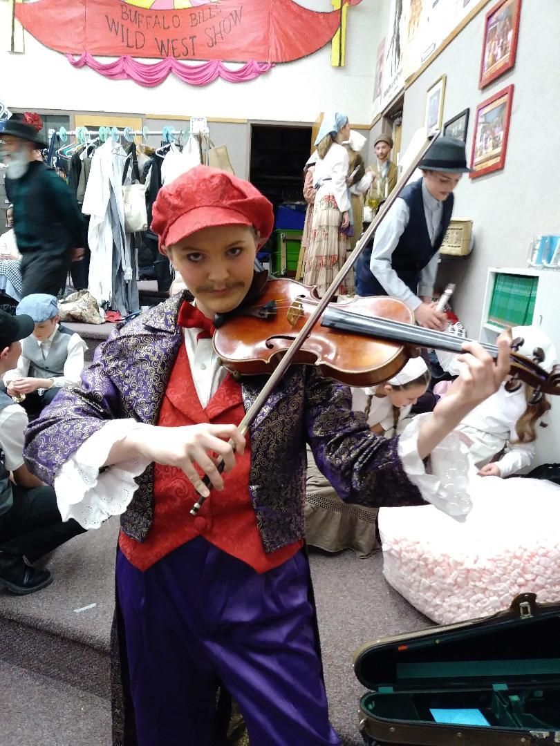 Student playing the fiddler in their school's prod