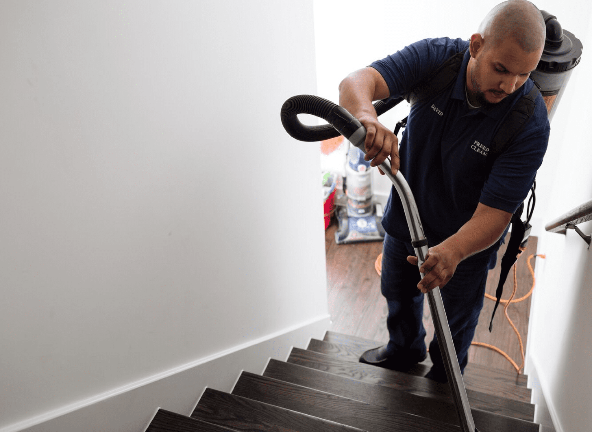 house cleaner vacuuming stairs