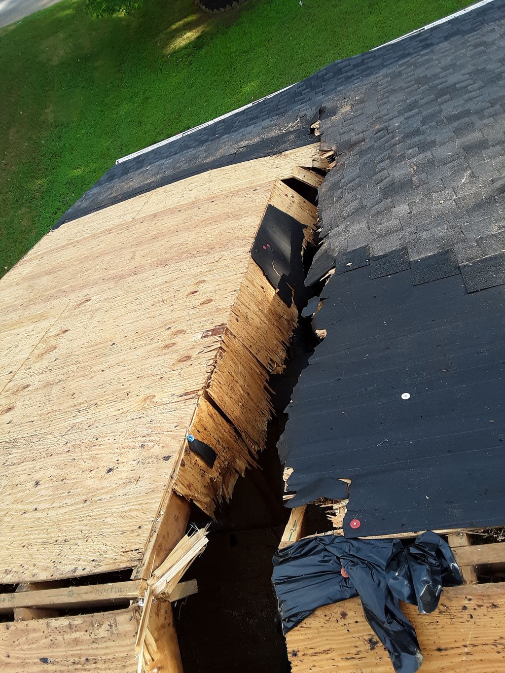 Broken sheathing on front of house.