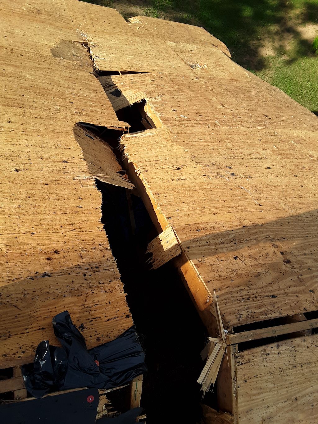 Broken sheathing on rear of house.