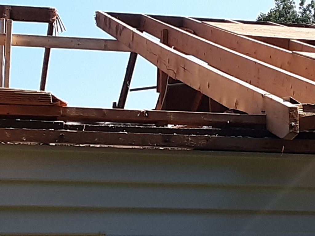 Broken rafters, ridge pole, and bracing.