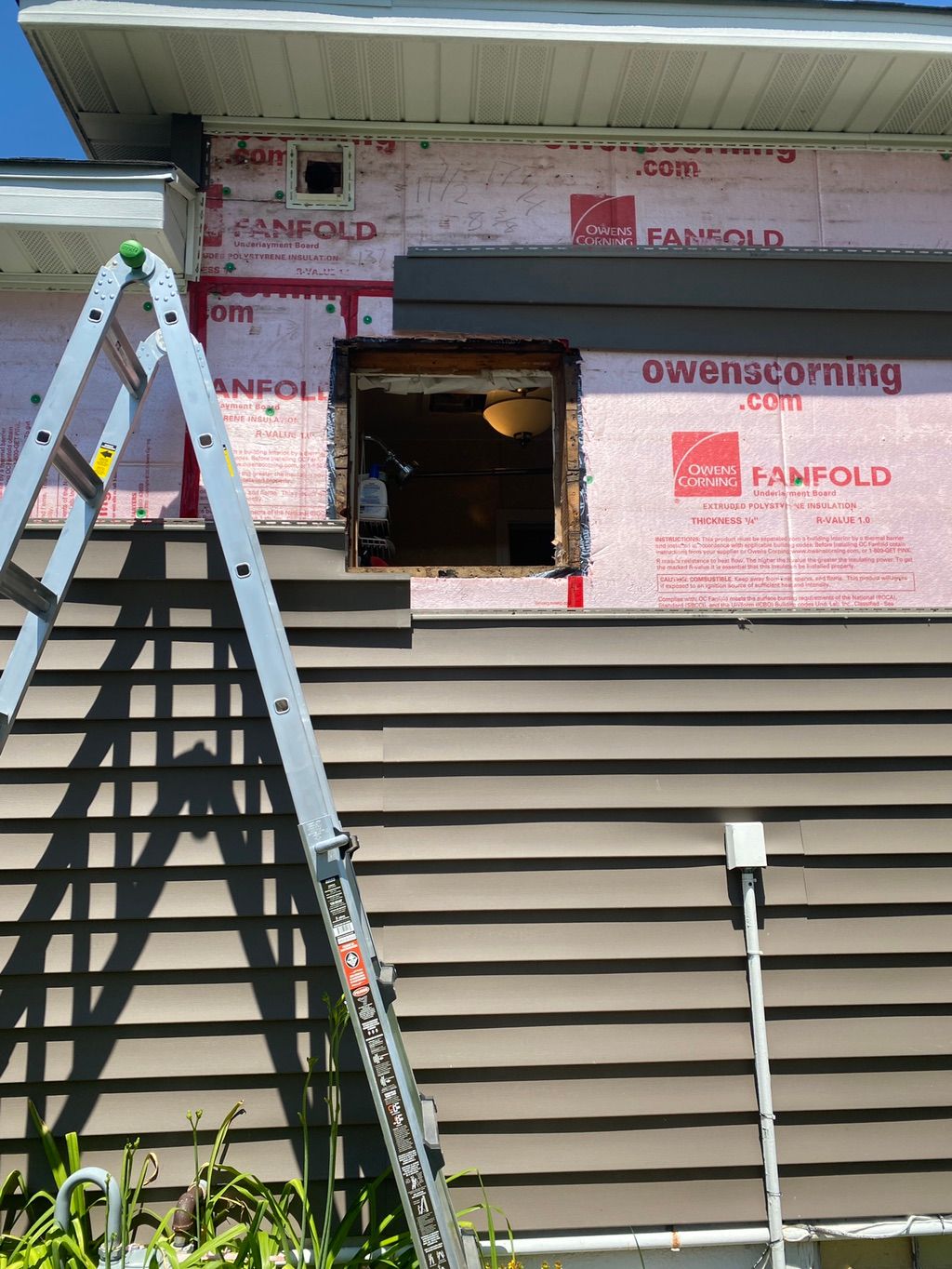 Window pulled out with vinyl siding