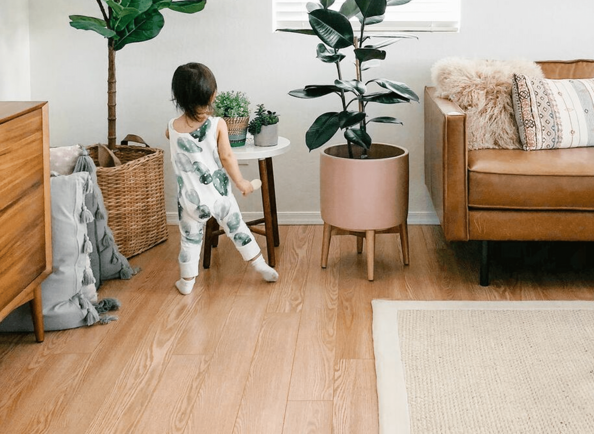 child walking on hardwood laminate flooring in living room