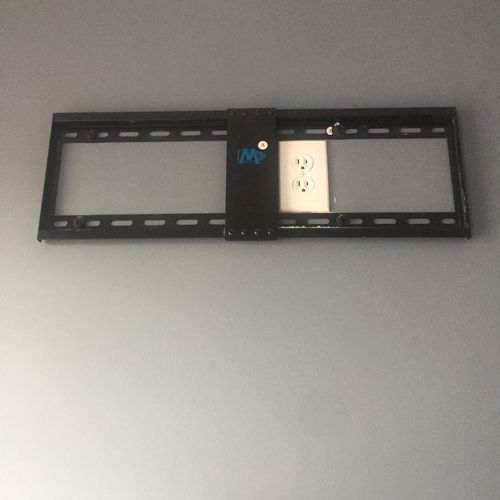 TV mount concealing outlet