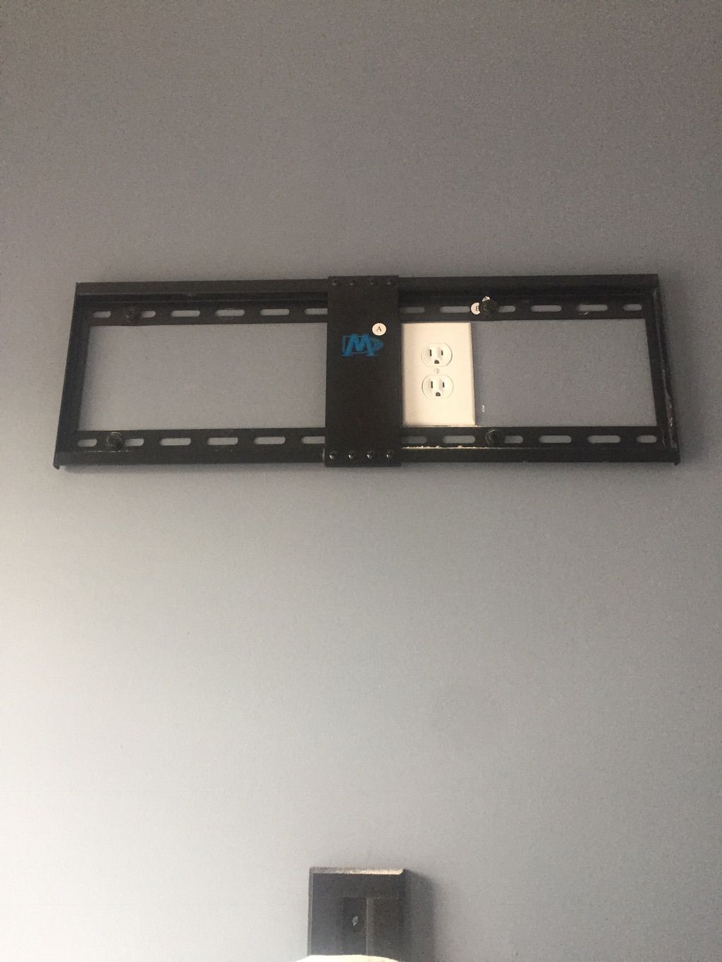TV mount concealing outlet