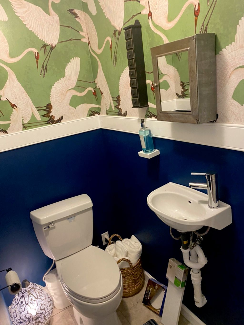 Powder room install with an up flush toilet and si