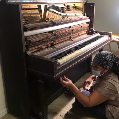 opening up the piano to fix stuck keys