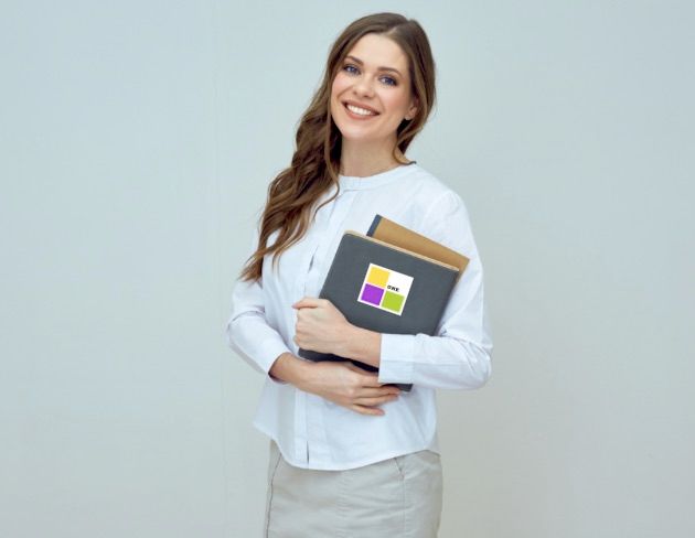 Amanda holding her notebook with a #ONE sticker