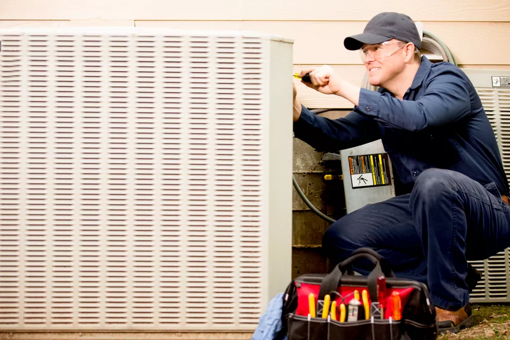 HVAC technician working on AC