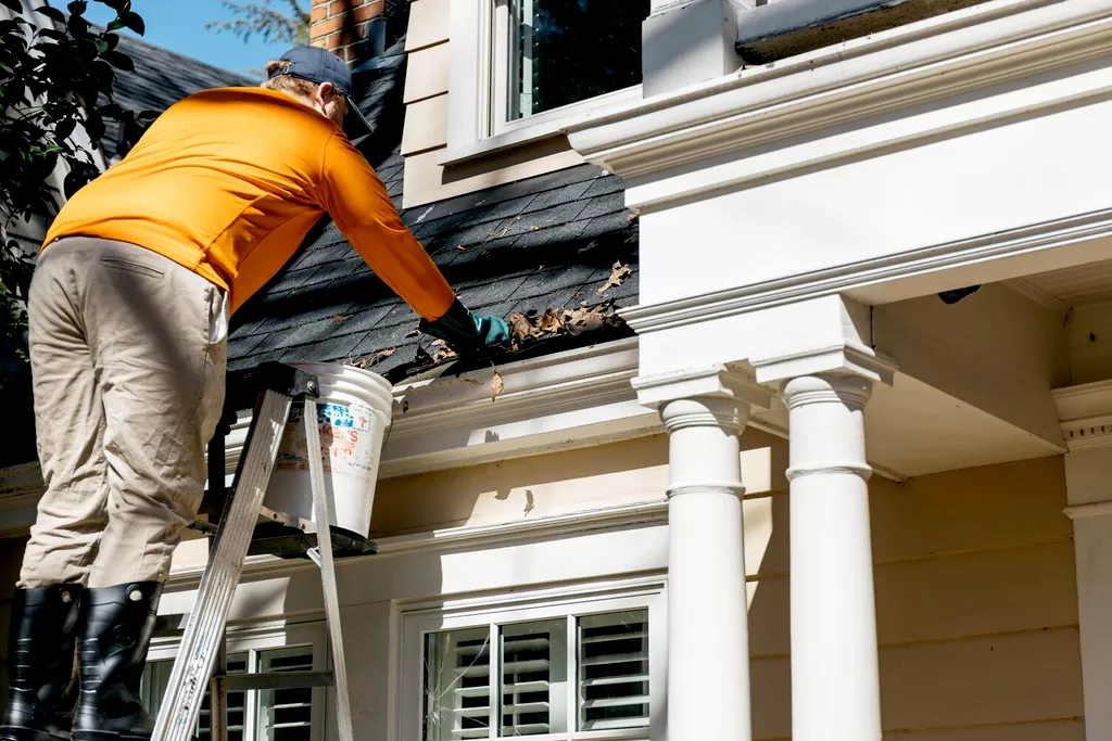 cleaning home gutters during fall
