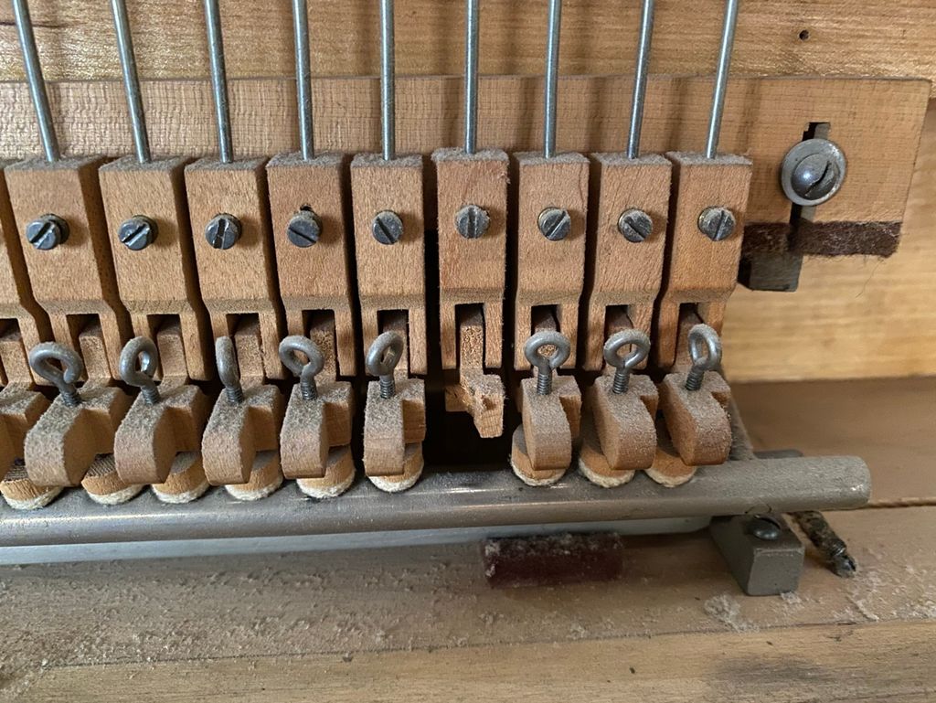 These parts control the dampers in a grand piano. 