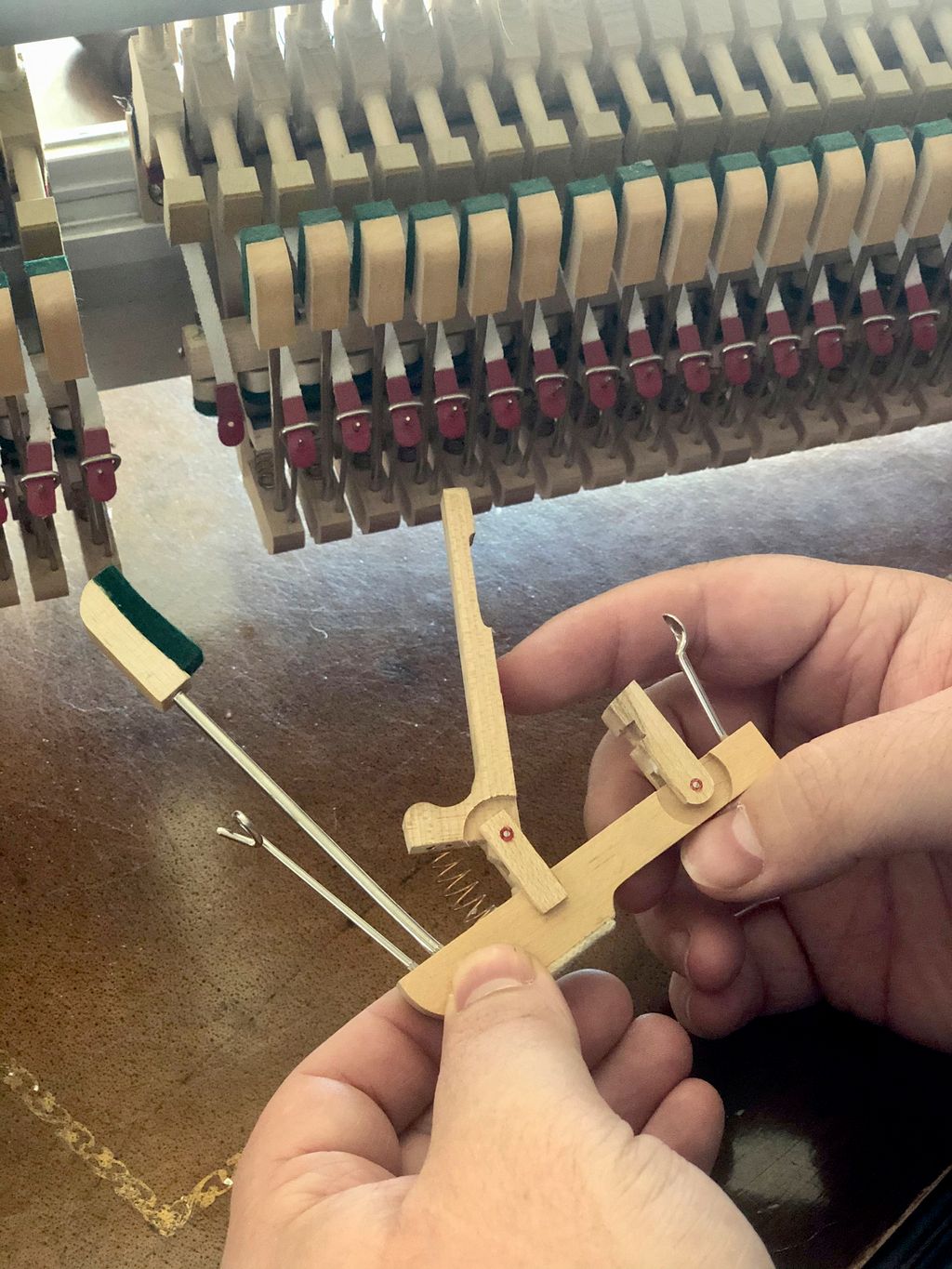 An upright piano wippen removed for service