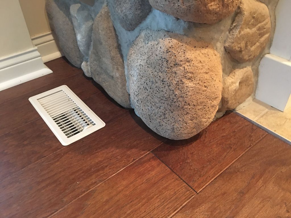 We installed hardwood around fireplace stone
