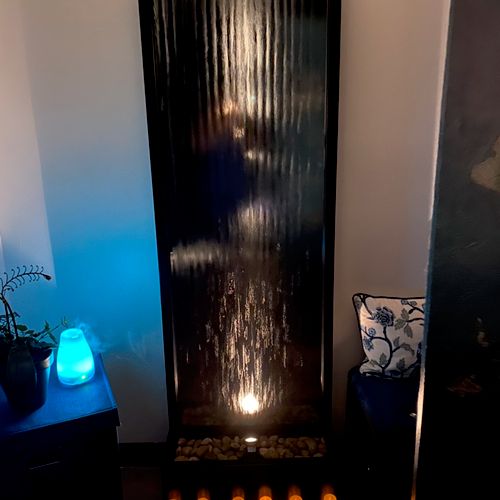 Relaxing waterfall fountain in the spa room
