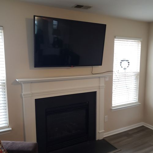 TV mount above fireplace.
